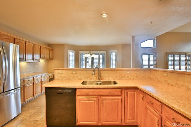 kitchen with sink, stainless steel refrigerator, black dishwasher, pendant lighting, and backsplash