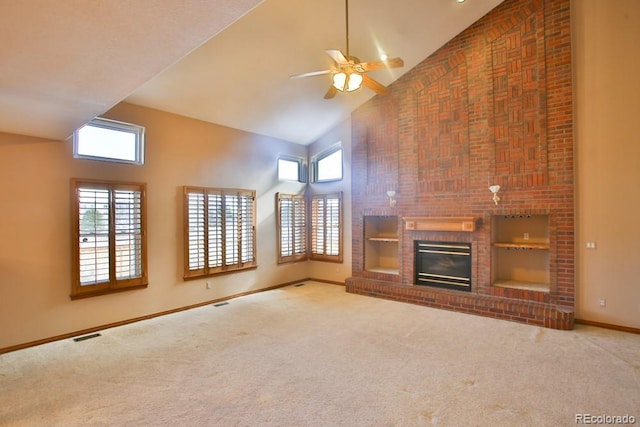 unfurnished living room with ceiling fan, carpet flooring, high vaulted ceiling, and a brick fireplace