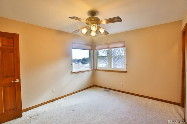 carpeted empty room featuring ceiling fan