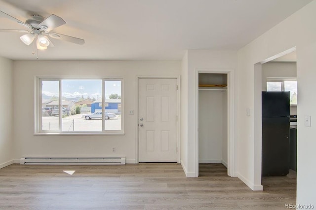 101 Harvard Ln, Buena Vista, CO 81211 - entryway with a baseboard radiator, light wood-style flooring, ceiling fan, and plenty of natural light