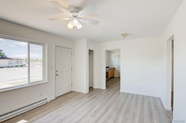 101 Harvard Ln, Buena Vista, CO 81211 - unfurnished room featuring a baseboard heating unit, light wood-style floors, baseboards, and a ceiling fan