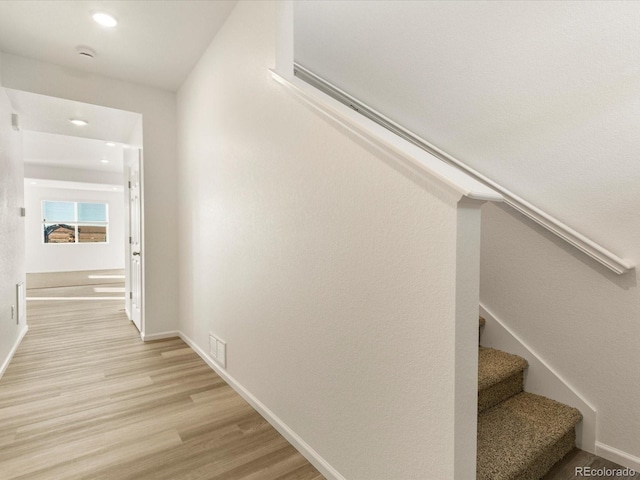 stairway with hardwood / wood-style floors