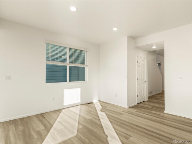 unfurnished room with light hardwood / wood-style floors