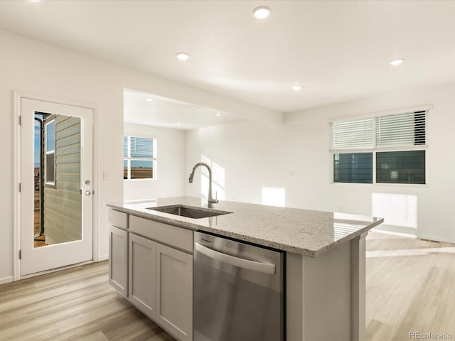 kitchen with dishwasher, sink, a center island with sink, and gray cabinetry