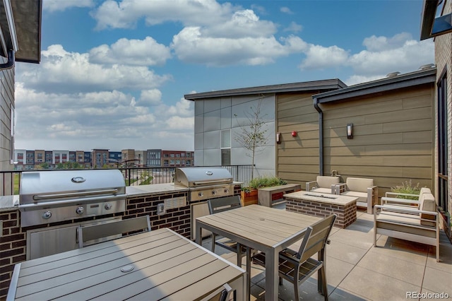 view of patio with a fire pit and area for grilling