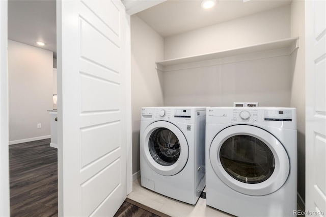 laundry area featuring wood-type flooring and independent washer and dryer