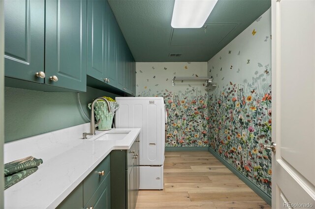 344 Saint Paul St, Denver, CO 80206 - laundry area featuring wallpapered walls, light wood-style floors, attic access, cabinet space, and baseboards
