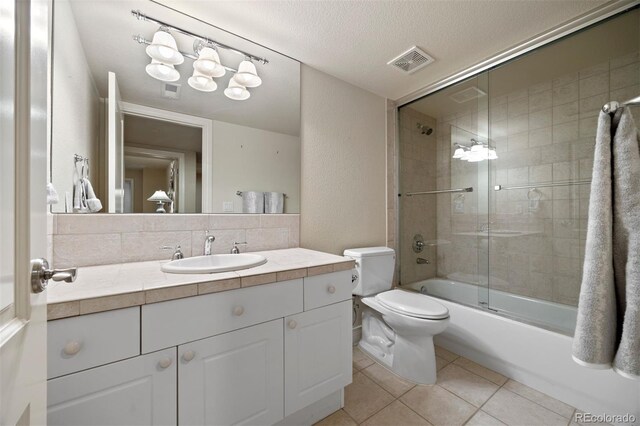 344 Saint Paul St, Denver, CO 80206 - bathroom with toilet, tile patterned floors, vanity, enclosed tub / shower combo, and a textured ceiling