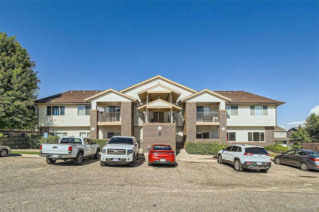 875 E 78th Ave Unit 9-2, Denver, CO 80229 - view of property featuring uncovered parking