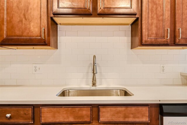 875 E 78th Ave Unit 9-2, Denver, CO 80229 - kitchen featuring light countertops, decorative backsplash, a sink, and dishwasher