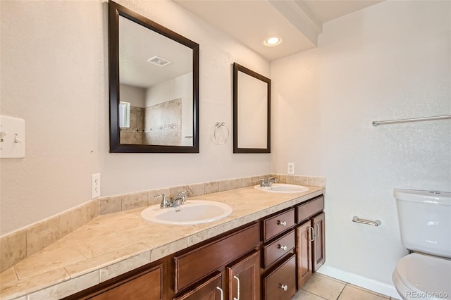 875 E 78th Ave Unit 9-2, Denver, CO 80229 - bathroom with double vanity, toilet, visible vents, and a sink
