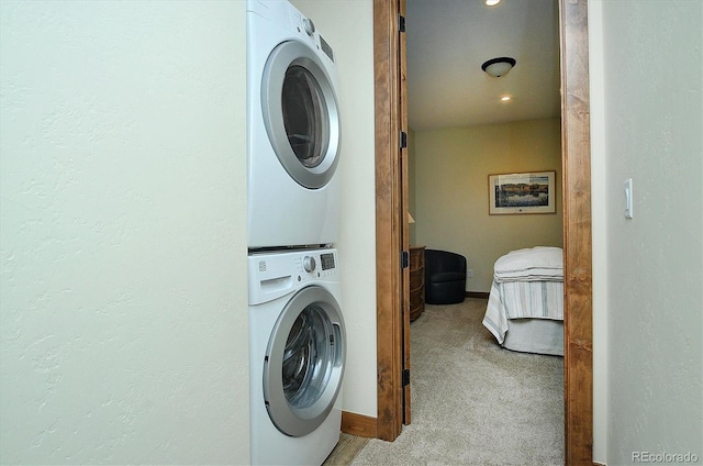 18202 Alta Vista Dr, Buena Vista, CO 81211 - laundry room featuring stacked washer and clothes dryer, carpet flooring, and baseboards