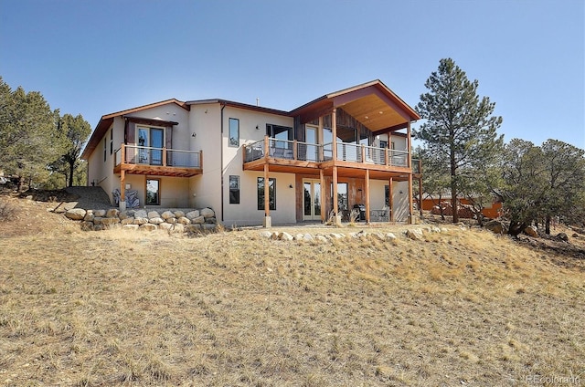 18202 Alta Vista Dr, Buena Vista, CO 81211 - rear view of property with stucco siding, french doors, and a balcony
