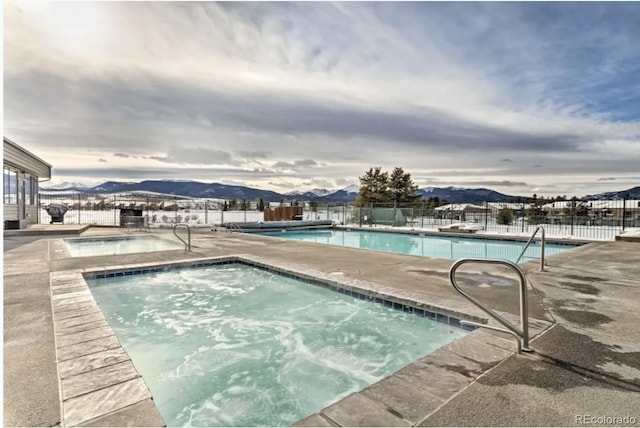 170 Gcr 838 Unit 6, Fraser, CO 80442 - community pool featuring a hot tub, a mountain view, and a patio