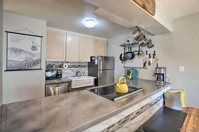 170 Gcr 838 Unit 6, Fraser, CO 80442 - kitchen featuring black appliances, a sink, tasteful backsplash, stainless steel countertops, and light brown cabinetry