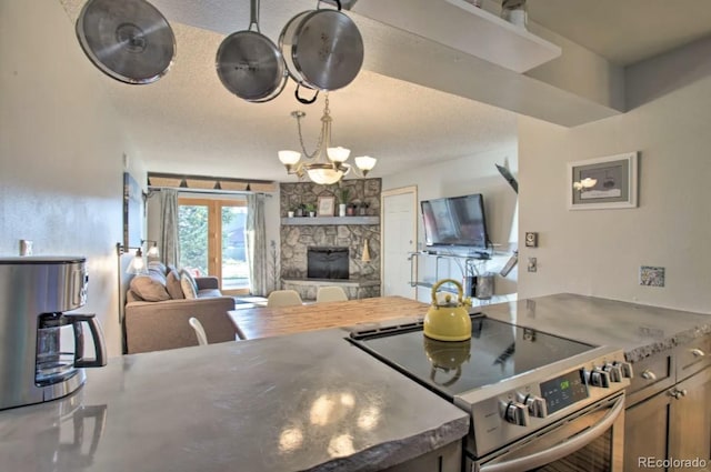 170 Gcr 838 Unit 6, Fraser, CO 80442 - kitchen featuring electric range, open floor plan, a fireplace, a textured ceiling, and a chandelier