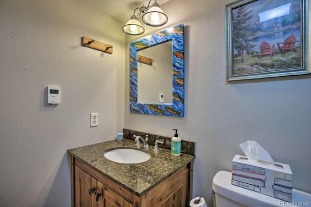 170 Gcr 838 Unit 6, Fraser, CO 80442 - bathroom with toilet, vanity, and a textured wall