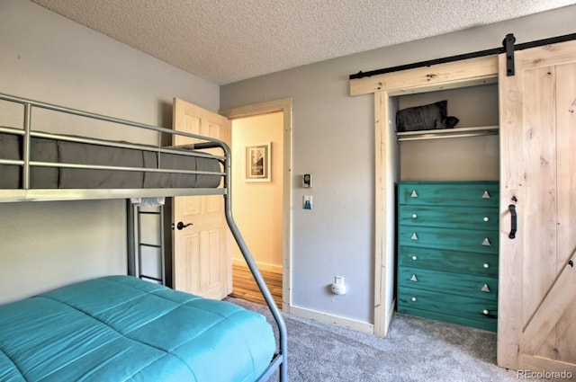 170 Gcr 838 Unit 6, Fraser, CO 80442 - bedroom featuring carpet, a closet, a barn door, baseboards, and a textured ceiling