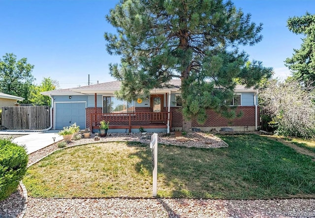 ranch-style house featuring a porch, an attached garage, brick siding, driveway, and a front lawn