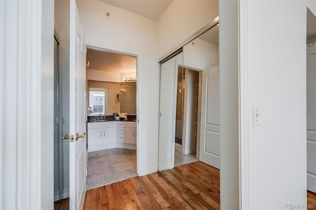 111 S Monroe St Unit B203, Denver, CO 80209 - hall with light wood finished floors and a sink