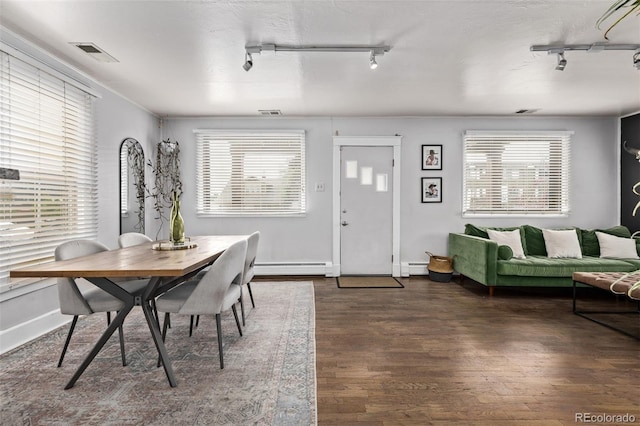 3464 S Downing St, Englewood, CO 80113 - dining area with rail lighting, baseboard heating, dark wood finished floors, and a baseboard radiator