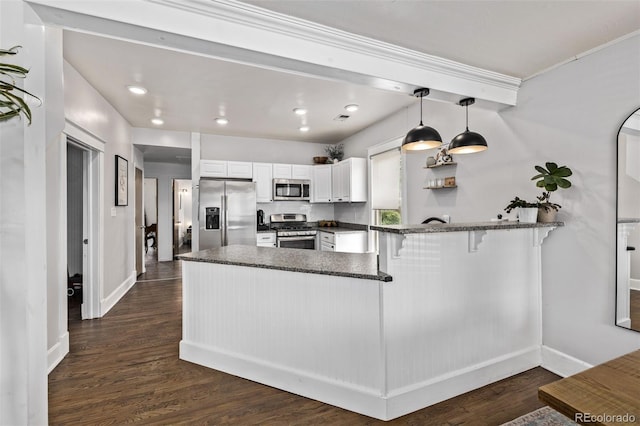 3464 S Downing St, Englewood, CO 80113 - kitchen with stainless steel appliances, a peninsula, white cabinets, decorative light fixtures, and dark wood finished floors