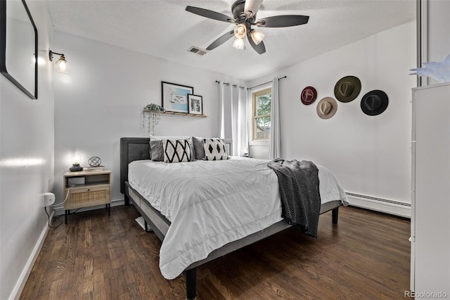 3464 S Downing St, Englewood, CO 80113 - bedroom with baseboard heating, dark wood-type flooring, a ceiling fan, and a textured ceiling