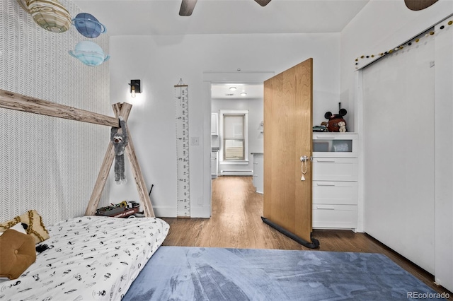 3464 S Downing St, Englewood, CO 80113 - bedroom with wood finished floors, baseboard heating, and a ceiling fan