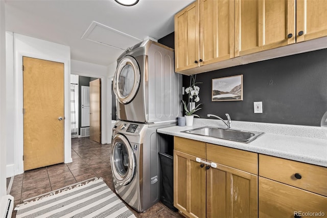 3464 S Downing St, Englewood, CO 80113 - laundry room with estacked washer and dryer, dark tile patterned floors, baseboard heating, and cabinet space