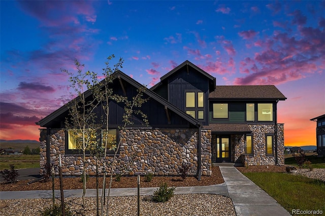 view of front of house featuring board and batten siding and stone siding