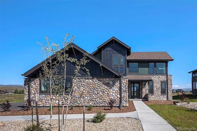 view of front of property featuring stone siding and board and batten siding