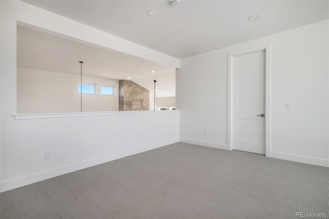 unfurnished room featuring carpet flooring, recessed lighting, lofted ceiling, and baseboards