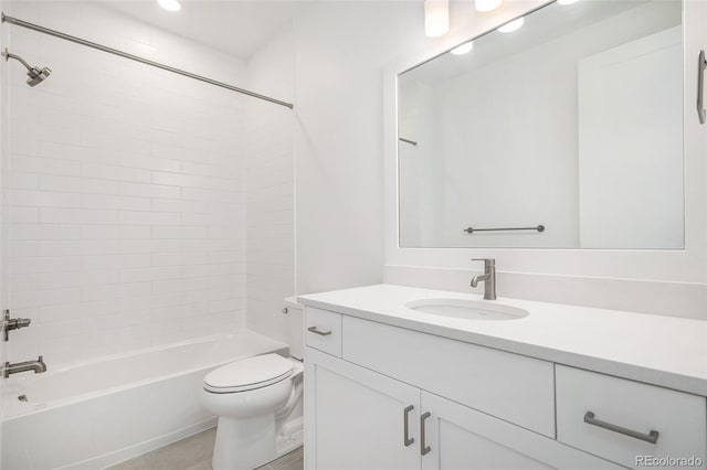 bathroom with tub / shower combination, toilet, and vanity