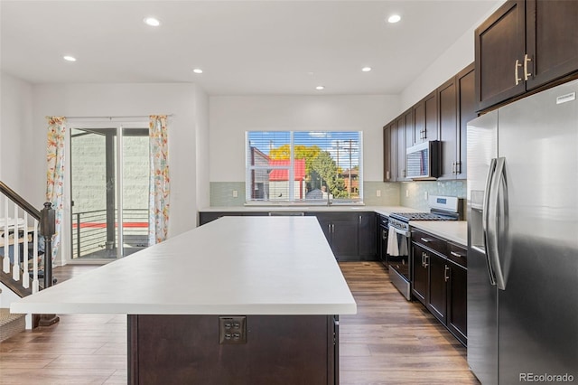 5173 Vivian St, Wheat Ridge, CO 80033 - kitchen with appliances with stainless steel finishes, light countertops, a kitchen island, healthy amount of natural light, and recessed lighting