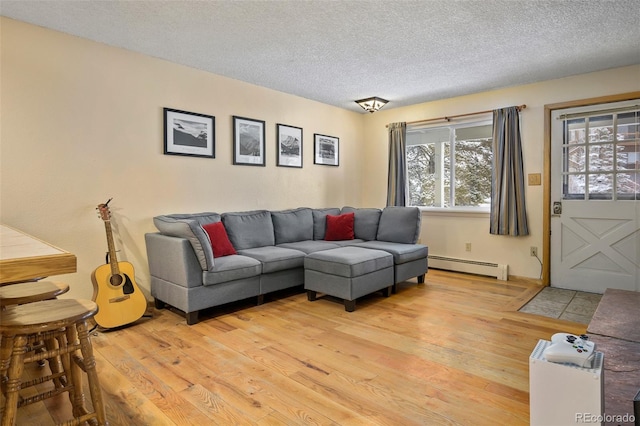 living room with light hardwood / wood-style floors, a textured ceiling, and a baseboard radiator