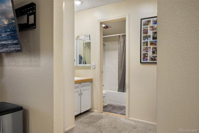 full bathroom with shower / bath combo, vanity, a textured ceiling, and toilet