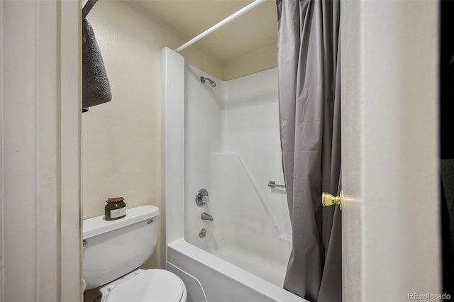 bathroom with shower / bath combo and toilet