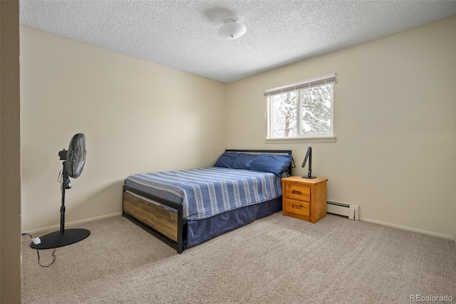 carpeted bedroom featuring a textured ceiling and a baseboard heating unit