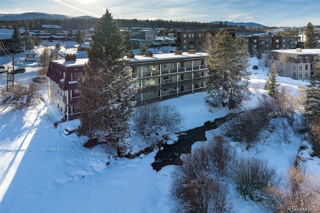 snowy aerial view with a mountain view