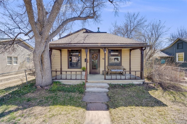306 E Cannon St, Lafayette, CO 80026 - bungalow-style house featuring a porch, fence, and a shingled roof