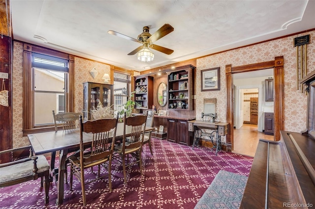 306 E Cannon St, Lafayette, CO 80026 - dining room featuring dark carpet, crown molding, ceiling fan, and wallpapered walls