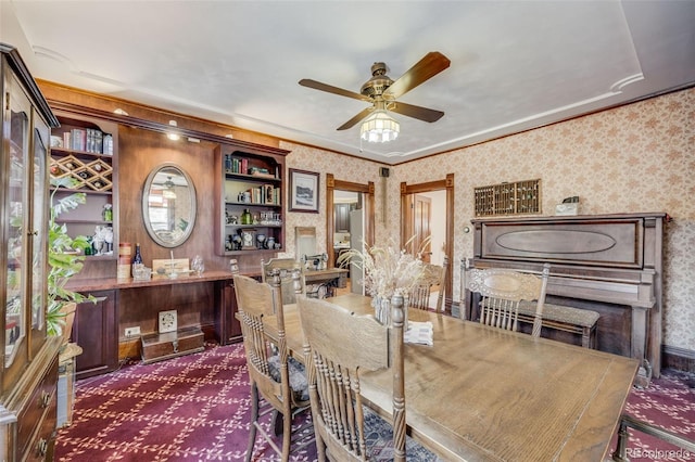 306 E Cannon St, Lafayette, CO 80026 - dining room with crown molding, ceiling fan, dark carpet, and wallpapered walls