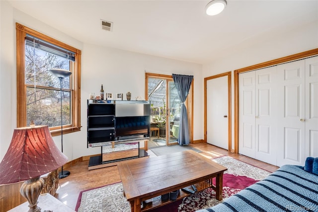 306 E Cannon St, Lafayette, CO 80026 - living area featuring baseboards, wood finished floors, and visible vents