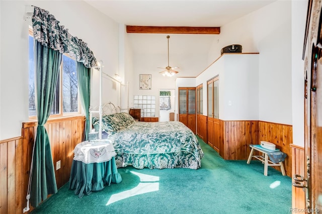 306 E Cannon St, Lafayette, CO 80026 - bedroom featuring a ceiling fan, carpet flooring, wainscoting, wooden walls, and vaulted ceiling with beams