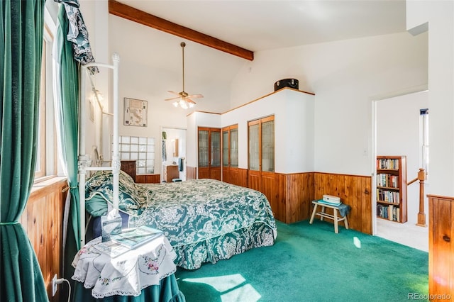 306 E Cannon St, Lafayette, CO 80026 - bedroom with wainscoting, multiple closets, wood walls, carpet, and vaulted ceiling with beams