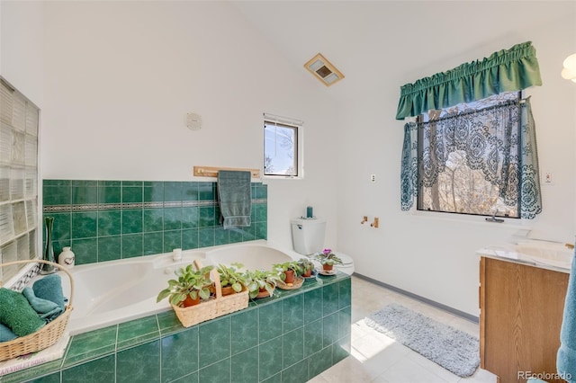 306 E Cannon St, Lafayette, CO 80026 - full bath with a garden tub, visible vents, tile patterned flooring, lofted ceiling, and vanity