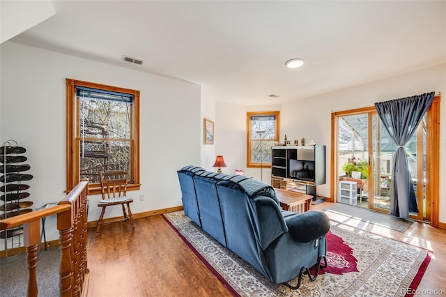 306 E Cannon St, Lafayette, CO 80026 - living area with plenty of natural light, baseboards, and wood finished floors