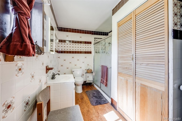 306 E Cannon St, Lafayette, CO 80026 - bathroom with toilet, a shower stall, wood finished floors, tile walls, and vanity
