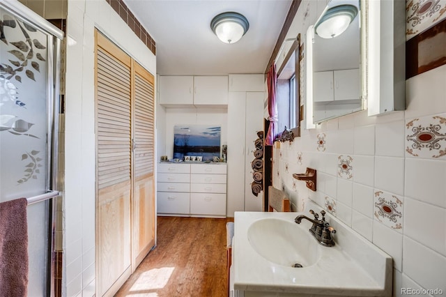 306 E Cannon St, Lafayette, CO 80026 - full bathroom featuring a stall shower, vanity, wood finished floors, and tile walls