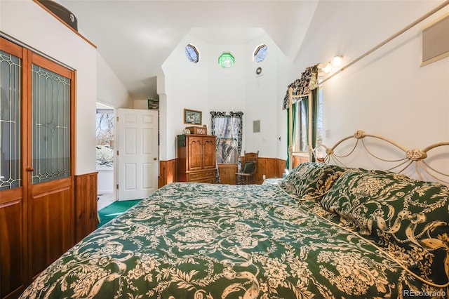 306 E Cannon St, Lafayette, CO 80026 - carpeted bedroom featuring lofted ceiling, french doors, and a wainscoted wall